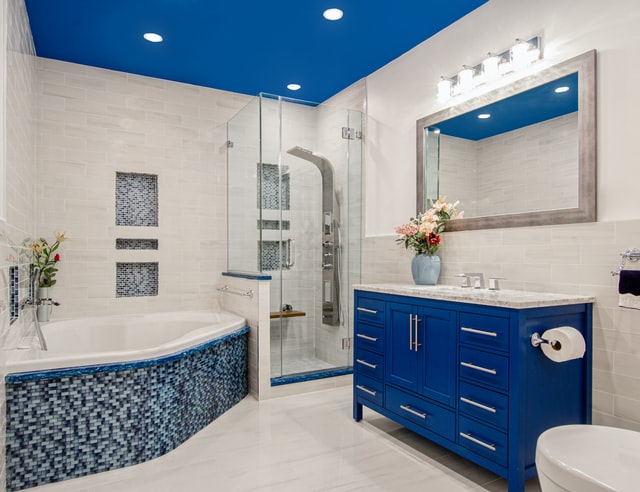 A modern bathroom with bright blue paint