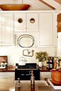 A small cream kitchen with ship-inspired hardware