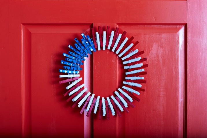 Front door wreath made with red, white, and blue clothespins