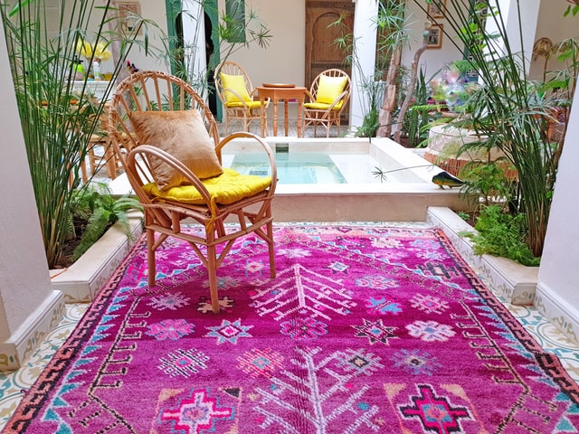 A vibrant rug in an outdoor living room