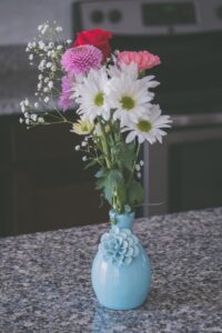 A few flowers in a blue vase