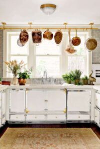 A small white kitchen with hanging pots