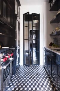 A small black galley kitchen with glass doors