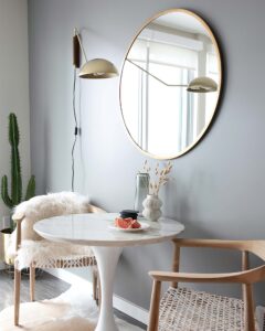 A small dining nook in front of a wall painted Seize the Gray by Clare