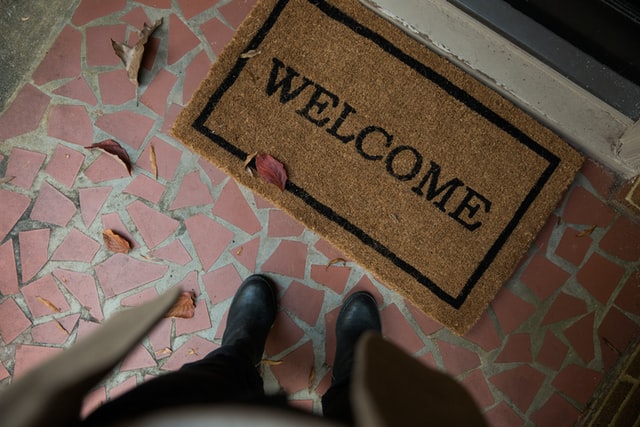 An entryway mat that reads “welcome”