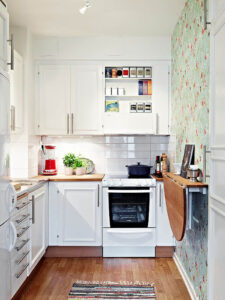 All-white kitchen with green floral wallpaper