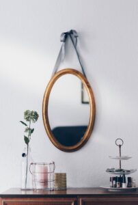 An oval mirror hung on a wall