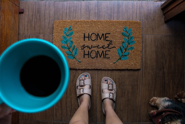 A floral doormat that reads “home sweet home”