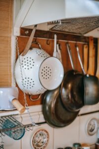 Different kitchen pots hung on a rack