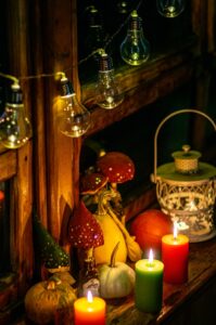 Small pumpkins beside candles decorated on a budget for fall