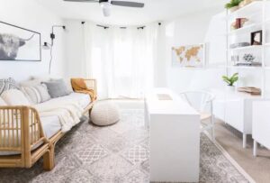 Small space living room with white desk and bamboo sofa