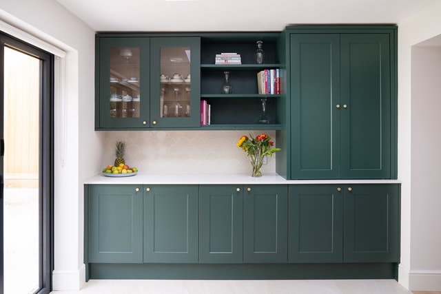 Kitchen cabinets painted in a greenish color