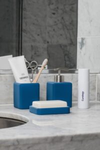 High-end soap, hand wash, and toothbrush on a bathroom sink