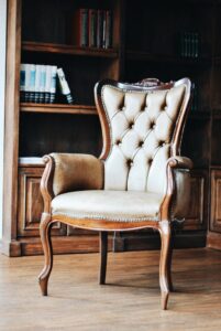 A classic brown leather chair places inside a Western study room