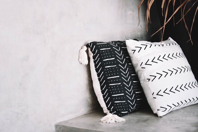 Two black and white patterned cushions