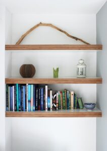 Different shelves containing books and other budget decorating items