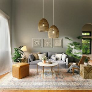 Living room with lampshades, framed wallpaper art, plants, a table, and a grey sofa that have different cushions on it